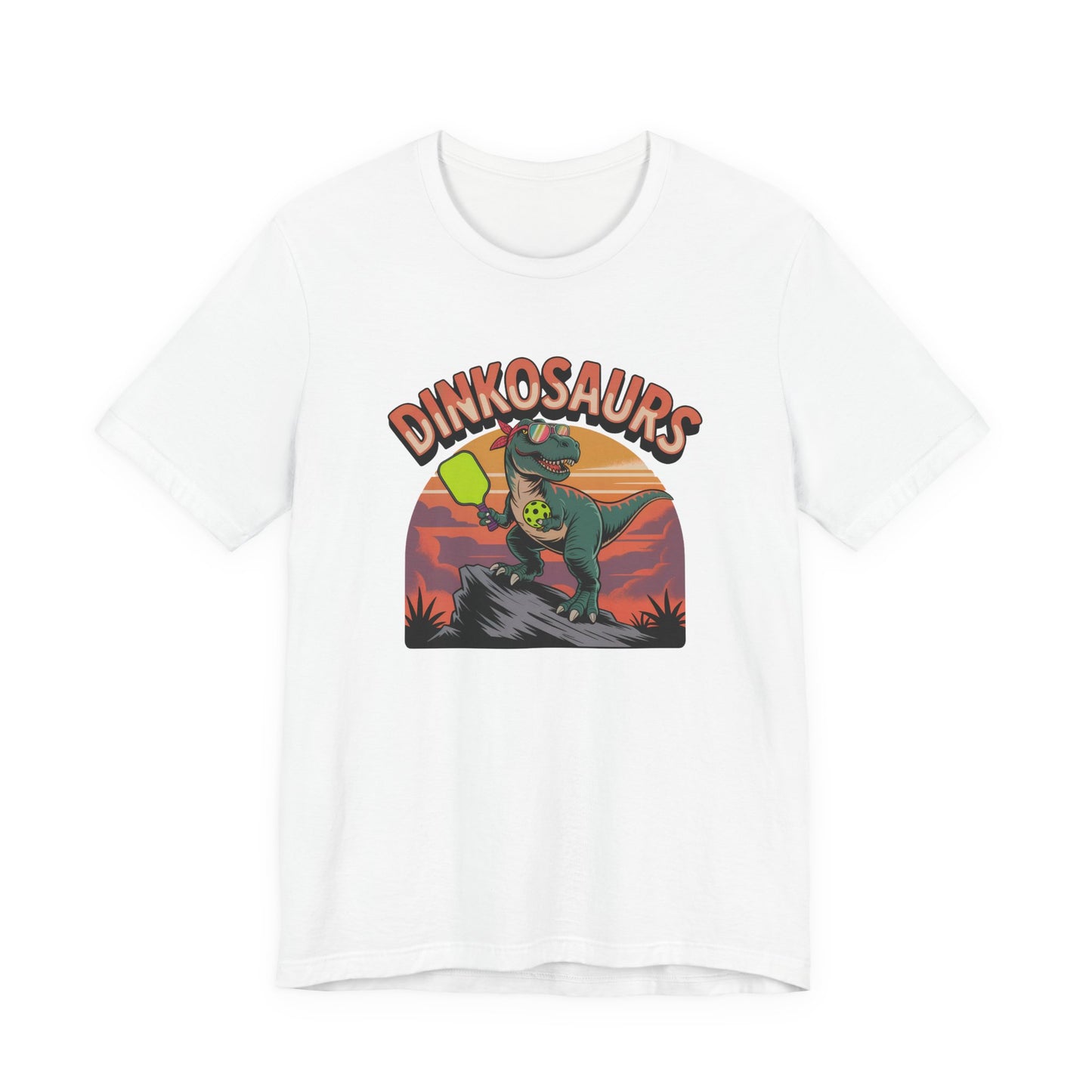 Dinkosaurs T‑Shirt — Retro Dino Holding Pickleball Paddle Graphic Tee